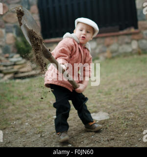 Little Boy scavando un foro Foto Stock