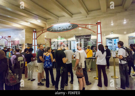 La Folla di sbavatura burger innamorati al Shake Shack in Grand Central Terminal di New York il Mercoledì, 12 agosto 2015. Il veloce trattoria informale ha recentemente riportato un 13% di salto nella stessa-negozio di vendita. Le catene stock è aumentato del 250% poiché la loro gennaio IPO. (© Richard B. Levine) Foto Stock