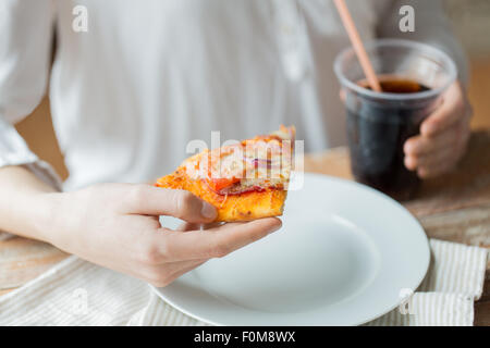 Close up di donna con pizza e coca cola drink Foto Stock