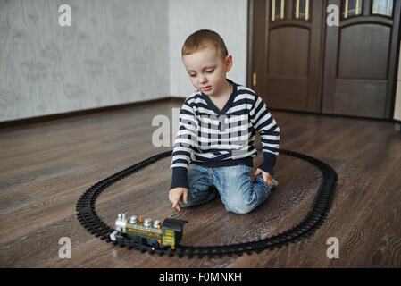 Little Boy costruisce ferrovia giocattolo Foto Stock