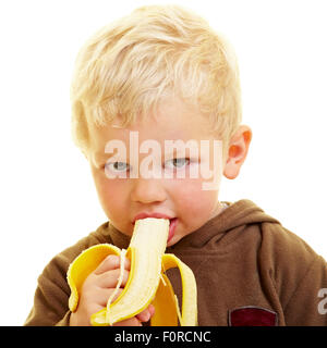 Giovane ragazzo mangia una banana Foto Stock