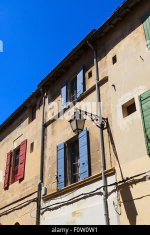 Lampione attaccato ad una vecchia casa francese con otturatori Foto Stock