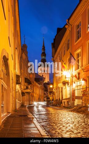 Strada con vista di St Olafs chiesa di notte, Tallinn, Estonia Foto Stock