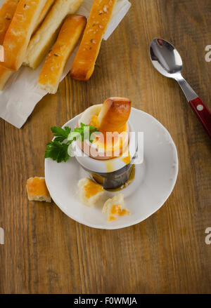 Uova sode per la Colazione La colazione è servita con pane su una tavola in legno rustico. Vista superiore Foto Stock