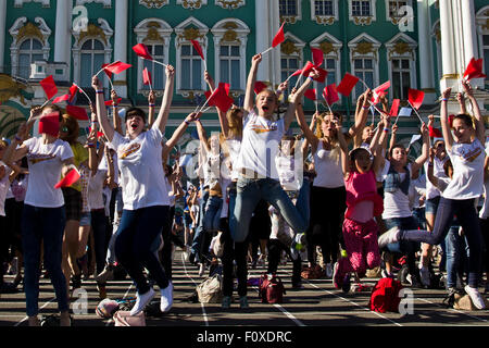 San Pietroburgo, Russia. Il 22 agosto, 2015. La bandiera nazionale di giorno è stato celebrato a San Pietroburgo il 22 agosto 2015. Diverse centinaia di giovani con piccoli rossi, blu e bandiere bianche performeed una danza sulla piazza del palazzo nella parte anteriore del Museo Hermitage. In Russia la bandiera attuale è stata introdotta dal Presidente Boris Eltsin al posto della vecchia bandiera sovietica e rimane uno dei pochi simboli della nuova Russia democratica che esiste fino ad oggi. Credito: studio204/Alamy Live News Foto Stock