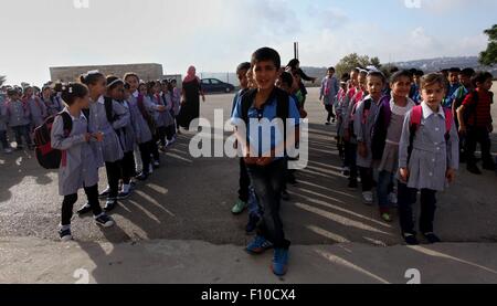 Duma, West Bank, Territorio palestinese. 24 Ago, 2015. Gli studenti palestinesi di stand in una linea nella loro scuola al mattino del primo giorno del nuovo anno di studio nella West Bank village della Duma, nei pressi di Nablus su agosto 24, 2015 Credit: Shadi Jarar'Ah/immagini APA/ZUMA filo/Alamy Live News Foto Stock