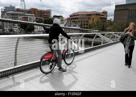 Un giovane corse a Santander noleggio moto su Millennium Bridge a Londra REGNO UNITO KATHY DEWITT Foto Stock