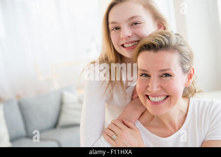 Caucasian madre e figlia sorridente in salotto Foto Stock