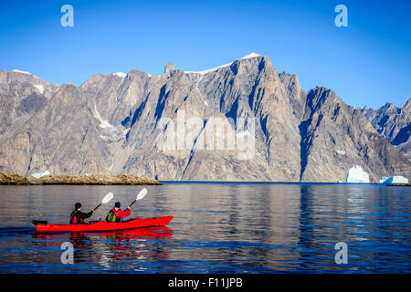 Persone paddling canoe vicino a formazioni di roccia di fiume in remoto Foto Stock