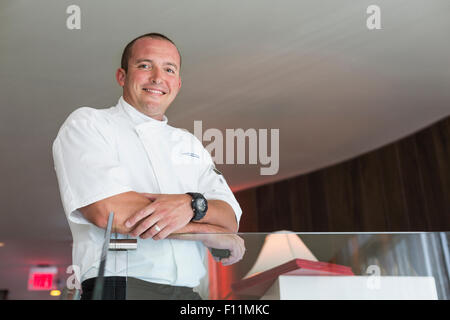 Basso angolo di visione dello chef in piedi in sala da pranzo Foto Stock