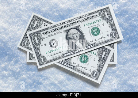Le banconote di dollari sulla neve sfondo in primo piano Foto Stock