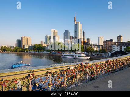 Amore serrature, ponte di ferro sul fiume Main, grattacieli del quartiere finanziario, Frankfurt am Main, Hesse, Germania Foto Stock