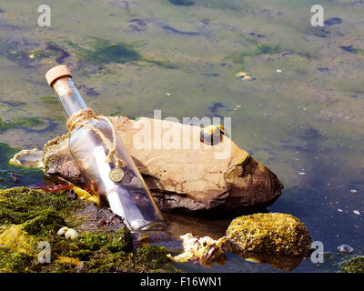 Un messaggio in bottiglia si è incagliata sulla spiaggia. Foto Stock