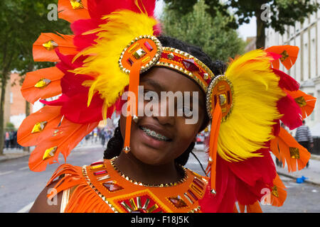 Londra, 30 agosto 2015. Una ragazza cammina per Ladbroke Grove sul suo modo di unire la sua troupe come festaioli aspettano l'inizio del carnevale di Notting Hill il giorno della famiglia. Credito: Paolo Davey/Alamy Live News Foto Stock