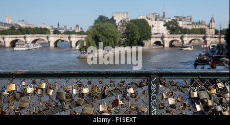 Primavera a Parigi: Amore si blocca sul Pont des Arts con la Senna e Pont Neuf oltre Foto Stock