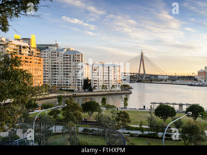 Vista di appartamenti affacciati Johnstons Bay a Pyrmont, Sydney Harbour, con l'Anzac Bridge in background. Foto Stock