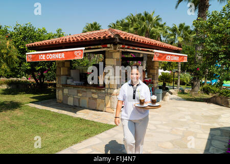 Una cameriera porta un vassoio di bevande in un gelato cafe Foto Stock