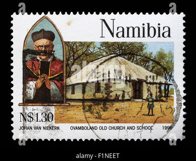 Timbro stampato in Namibia mostra l Arcivescovo Joseph Gotthardt, Ovamboland vecchia chiesa e la scuola e circa 1966 Foto Stock