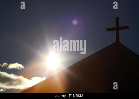 Sun simbolica e la cappella con la croce di legno Foto Stock