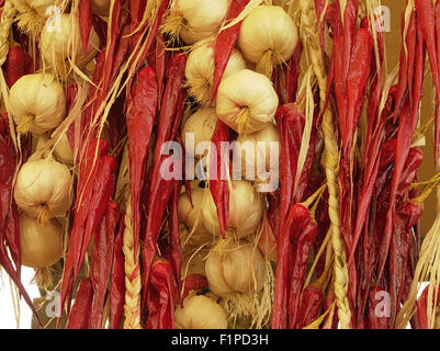 Mix di aglio e hot chilis appesi al muro nel tipico mercato nel Sud Italia Foto Stock