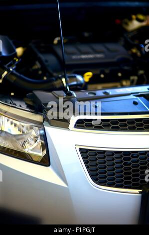 Sotto il cofano - Riparazione Veicolo moderno. Auto moderna il motore sotto il cofano. Foto verticale Foto Stock