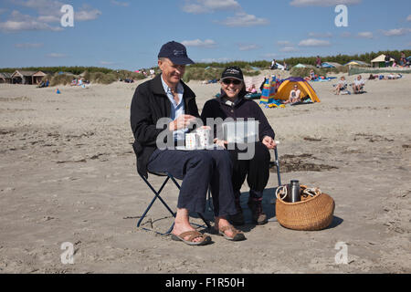 Wittering, Sussex, Regno Unito. 6 Settembre, 2015. Tè per due sulla spiaggia in West Wittering, West Sussex, Regno Unito 06.09.2015 un paio di godere del bel tempo in un modo molto bagnato Autunno in tutto il Regno Unito. Domenica ha portato buone temperature e cielo blu in tutta l'Inghilterra meridionale portando decine di persone per la spiaggia di West Wittering nelle vicinanze del Chichester. Credito: Jeff Gilbert/Alamy Live News Foto Stock