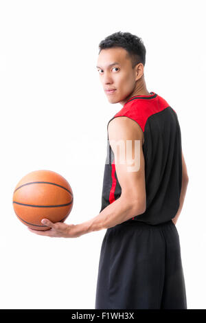 Asian giovane giocatore di basket su sfondo bianco Foto Stock
