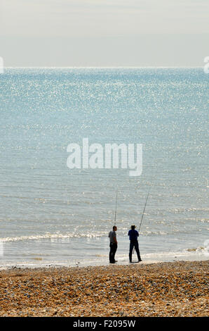 Bexhill-on-Sea, East Sussex, Inghilterra, Regno Unito. Due uomini la pesca sulla spiaggia Foto Stock