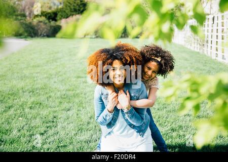 Madre e figlia con il binocolo, guardando in alto, puntando Foto Stock