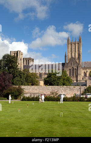 Le persone che giocano il croquet nei giardini del Palazzo dei Vescovi accanto alla Cattedrale di Wells, pozzi, Somerset England Regno Unito Foto Stock