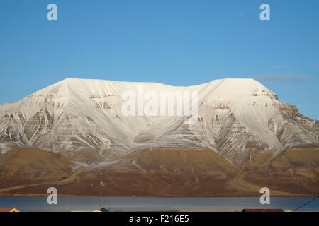 Norvegia Isole Svalbard, Longyearbyen, vista attraverso Adventfjorden verso Snow capped mountain. Foto Stock