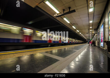 Un treno sotterraneo che passa attraverso St Stazione della metropolitana James Park. Metropolitana di Londra, Regno Unito Foto Stock