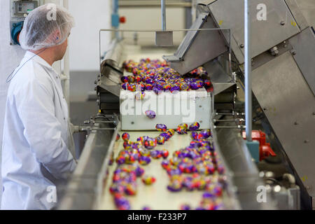 Regno Unito, Bournville : un lavoratore ispeziona la fine della linea di produzione per la Cadbury Creme uova in Bournville. Foto Stock