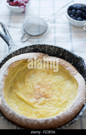 Dutch Baby crêpe in una padella in ghisa con frutti di bosco Foto Stock