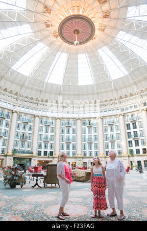 Caucasian multi-generazionale famiglia guardare in alto verso il soffitto a cupola in sei piani con atrio a West Baden Springs Resort Foto Stock
