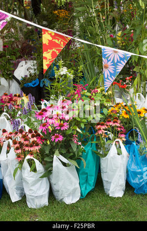 Acquistate i fiori in sacchetti di plastica in attesa di essere raccolti ad RHS Wisley flower show. Surrey, Inghilterra Foto Stock