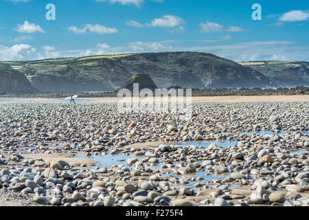 Surfer dirigendosi verso il mare a Widemouth Bay North Cornwall, Regno Unito Foto Stock