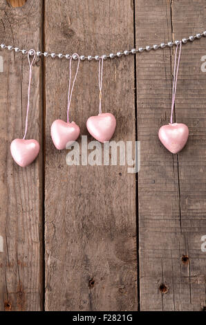 Vintage forme di cuore su un rustico sfondo di legno, il concetto di amore Foto Stock