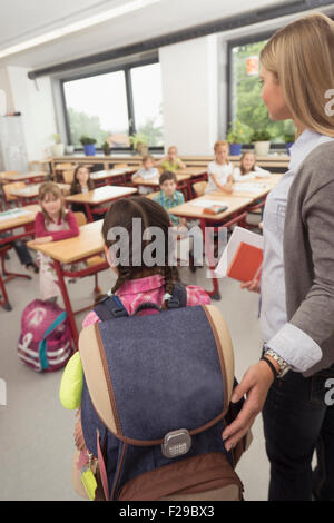 Insegnante femmina introducendo un nuovo compagno di classe in aula, Monaco di Baviera, Germania Foto Stock