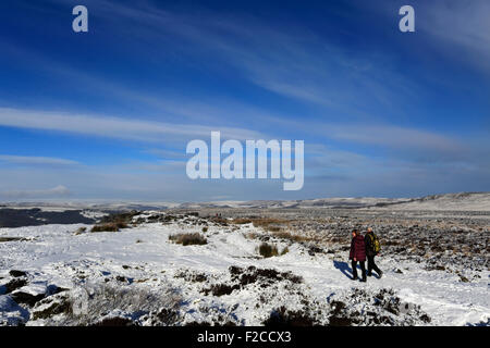 In inverno la neve, maschio adulto walker sul bordo Curbar, Parco Nazionale di Peak District, Derbyshire, England, Regno Unito Foto Stock