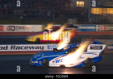 Top Fuel Funny auto drag racing a Santa Pod. Gordon Smith alla guida di una Dodge Stratus lato lontano v Kevin Kent in una Ford Mustang. Foto Stock