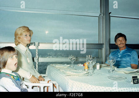 Der amerikanische Schauspieler Charles Bronson mit Ehefrau Jill Ireland und Tochter Zuleika im Restaurant, Frankreich 1970er Jahre. Attore americano Charles Bronson rilassante wit di sua moglie Jill Ireland e la figlia Zuleika presso un ristorante, la Francia degli anni settanta. 24x36VAID6 Foto Stock