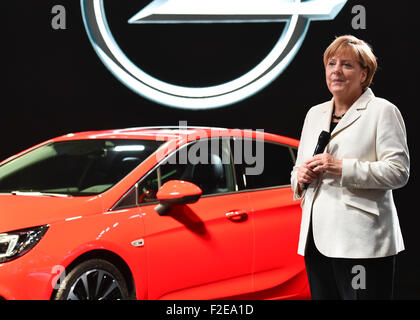 Francoforte, Germania. Xvii Sep, 2015. Il cancelliere tedesco Angela Merkel (CDU) sorge accanto a un Astra auto presso lo stand del costruttore di auto Opel durante la fase di apertura della International Motor Show IAA di Francoforte sul Meno, Germania, 17 settembre 2015. Dal 17 al 27 settembre i produttori di tutto il mondo mostra le innovazioni del settore automobilistico. Foto Stock