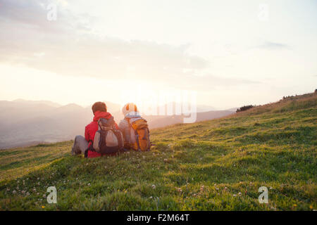 Austria, Tirolo, Unterberghorn, due escursionisti in appoggio nel paesaggio alpino di sunrise Foto Stock