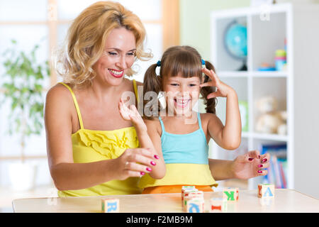 La famiglia felice gioca in casa interno Foto Stock