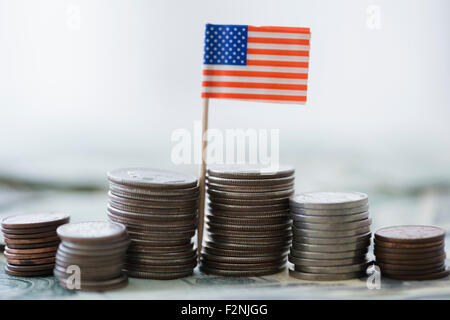 Close up di pile di monete con bandiera americana Foto Stock