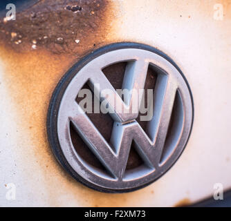 Il logo aziendale di Volkswagen su un arrugginito Volkswagen Golf di fronte lo stabilimento della società a Wolfsburg, in Germania, il 25 settembre 2015. Foto: OLE SPATA/dpa Foto Stock