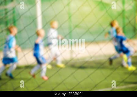 Ragazzi che giocano a calcio, defocussed sfocatura dello sfondo dello sport Foto Stock