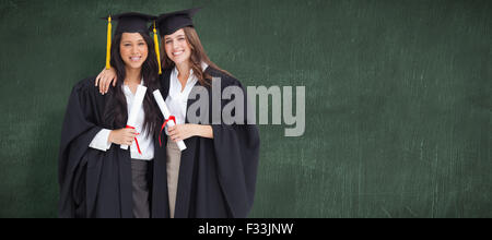 Immagine composita di due donne che abbraccia ogni altro dopo che si è laureato dall'università Foto Stock