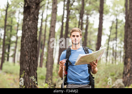 Giovane bello escursionista usando la mappa Foto Stock